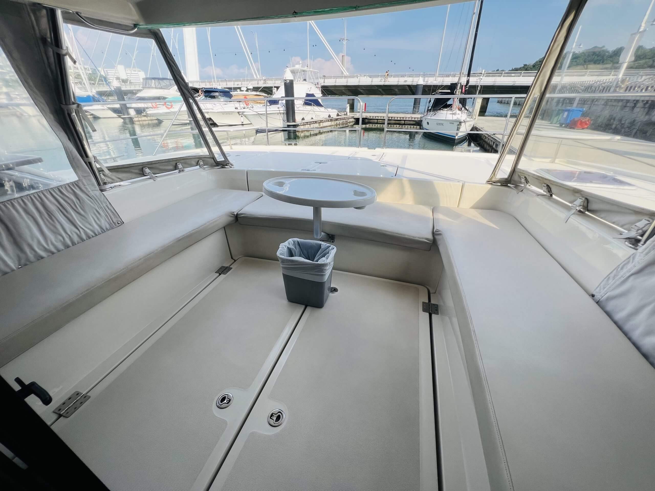 The 2018 Aquila 48 Power Catamaran – Flybridge lounge with pedestal table – Avelis Yachts Singapore