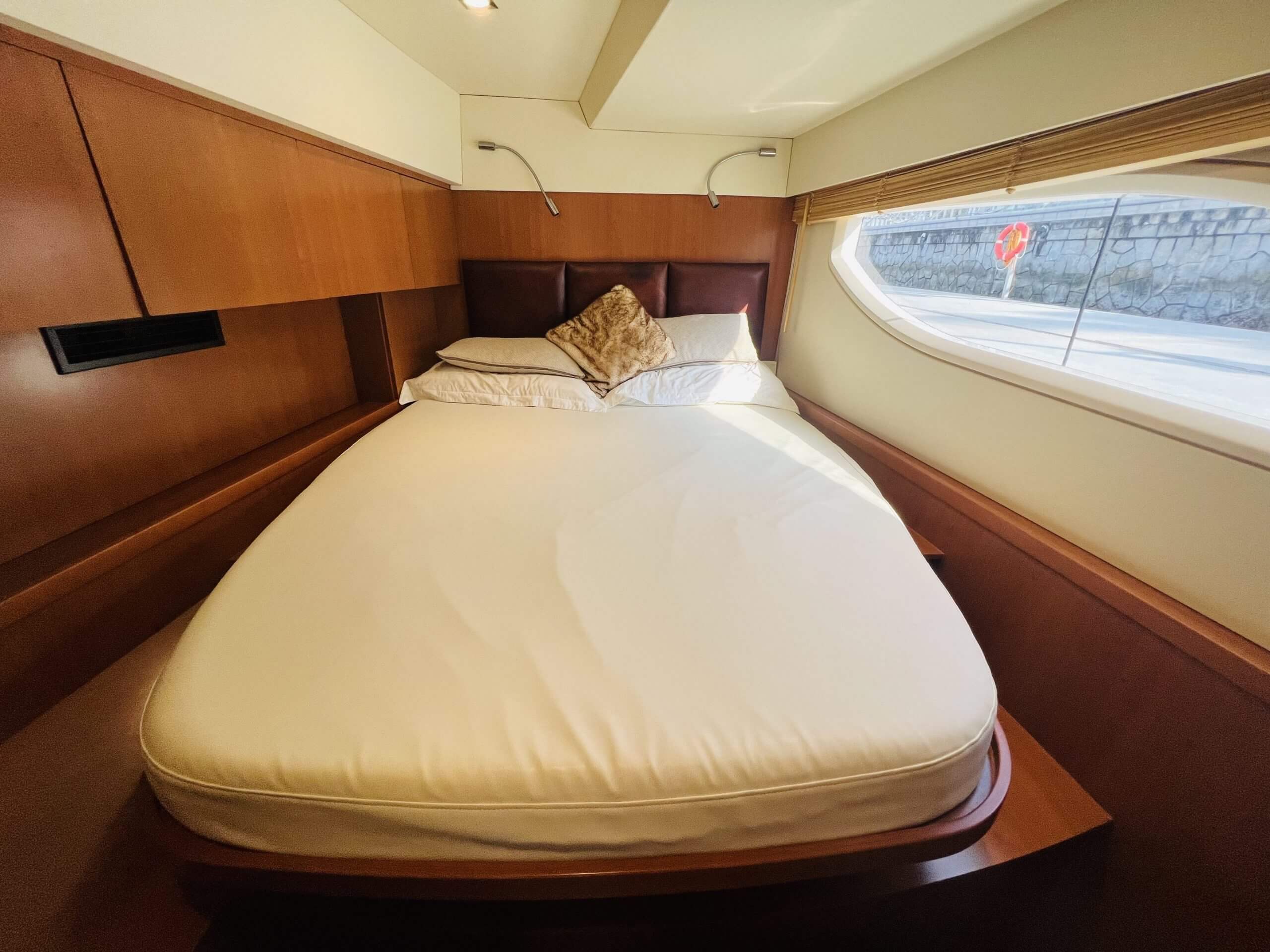 The 2018 Aquila 48 Power Catamaran – Guest cabin with double berth and hull window – Avelis Yachts Singapore