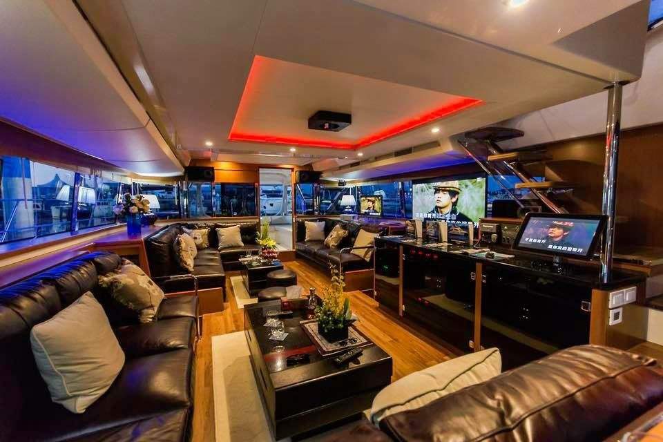 The 2018 Aquila 48 Power Catamaran – Salon lounge at night with red ceiling lighting – Avelis Yachts Singapore