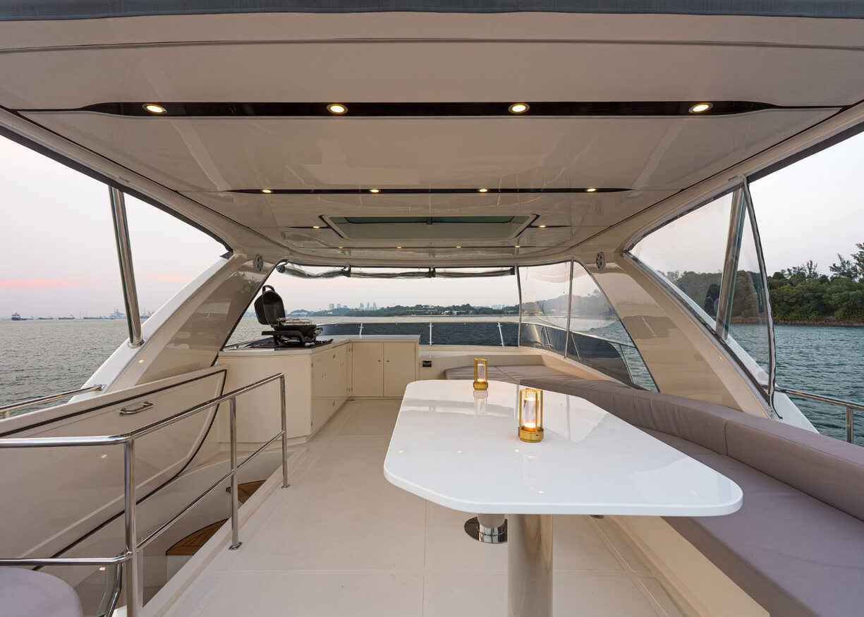 The Aquitalia 68 Motor Yacht – Aft deck dining table under the hardtop – Avelis Yachts Singapore